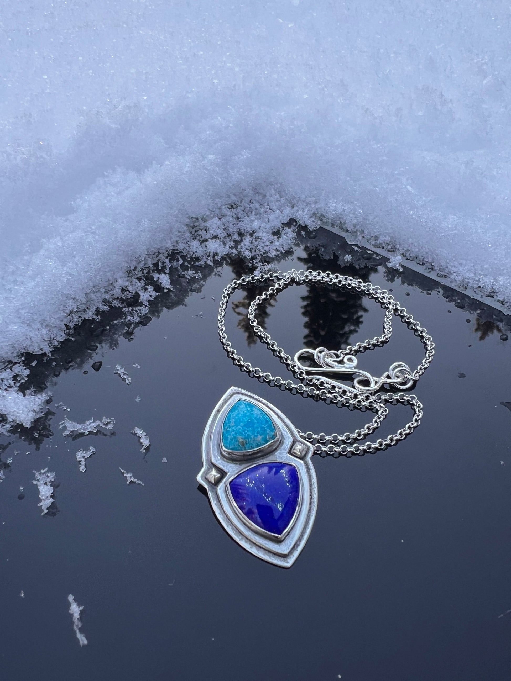 Handcrafted necklace featuring a bright blue Persian Turquoise and deep blue Lapis. Hung on a rolo chain with a handmade hook and eye clasp. 